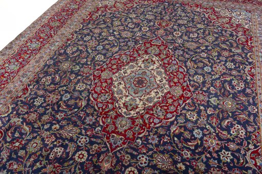 Backside of handmade 2000s Kashan rug showing knot structure and weave density