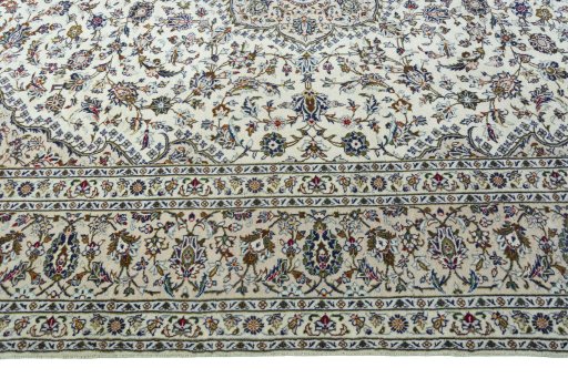 Corner detail of 2000s Kashan rug showing border pattern and Wool pile