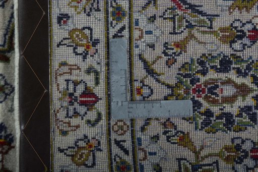 Backside of handmade 2000s Kashan rug showing knot structure and weave density