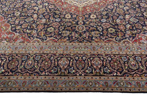 Corner detail of 2000s Kashan rug showing border pattern and Cork pile