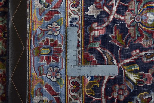 Backside of handmade 2000s Kashan rug showing knot structure and weave density