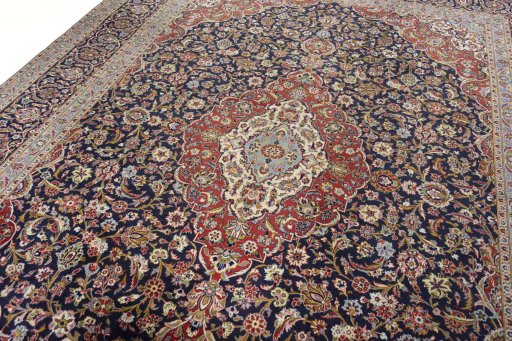 Backside of handmade 2000s Kashan rug showing knot structure and weave density