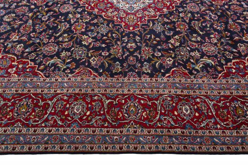 Corner detail of 2000s Kashan rug showing border pattern and Wool pile