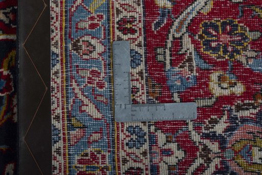 Backside of handmade 2000s Kashan rug showing knot structure and weave density