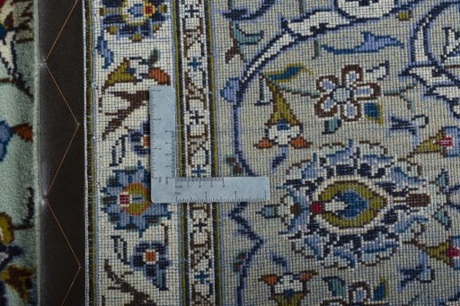 Backside of handmade 2000s Kashan rug showing knot structure and weave density