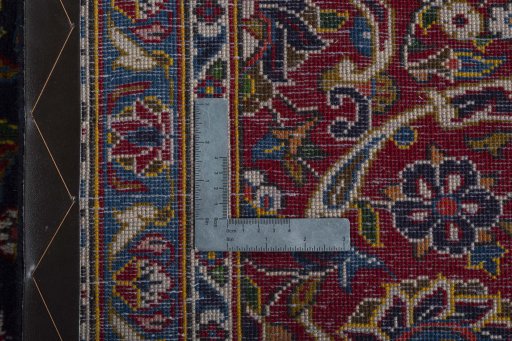 Backside of handmade 2000s Kashan rug showing knot structure and weave density