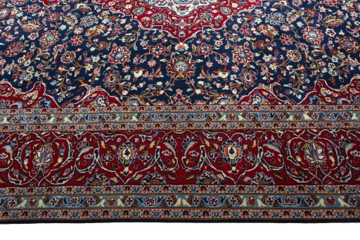 Corner detail of 2000s Kashan rug showing border pattern and Wool pile