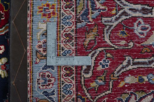 Backside of handmade 2000s Kashan rug showing knot structure and weave density