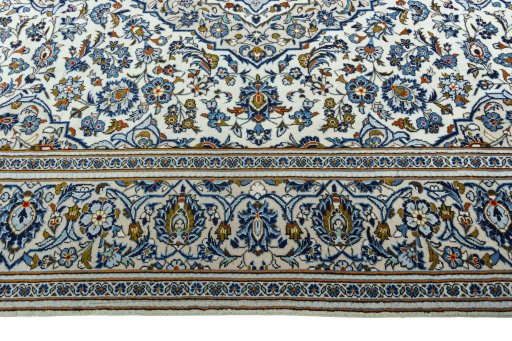 Corner detail of 2000s Kashan rug showing border pattern and Wool pile