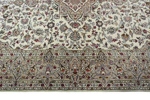 Corner detail of 2000s Kashan rug showing border pattern and Wool pile