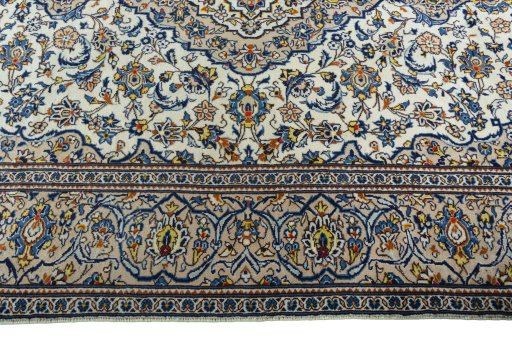Corner detail of 2000s Kashan rug showing border pattern and Wool pile