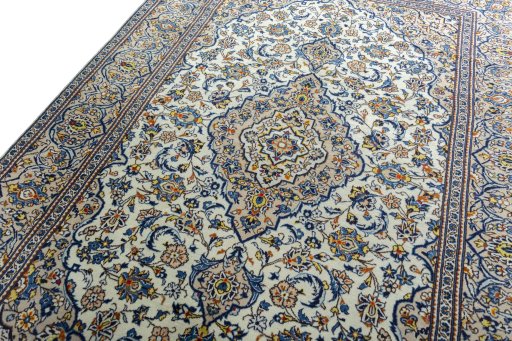 Backside of handmade 2000s Kashan rug showing knot structure and weave density