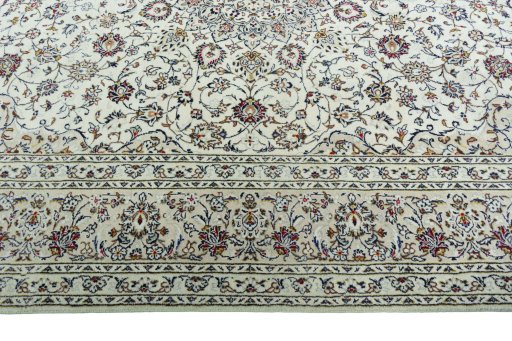 Corner detail of 2000s Kashan rug showing border pattern and Wool pile