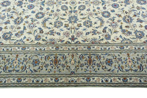Corner detail of 2000s Kashan rug showing border pattern and Wool pile