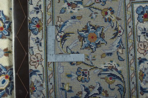 Backside of handmade 2000s Kashan rug showing knot structure and weave density