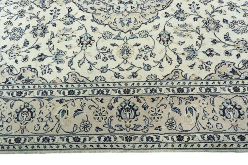 Corner detail of 2000s Kashan rug showing border pattern and Wool pile