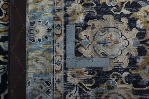 Backside of handmade 2000s Kashan rug showing knot structure and weave density