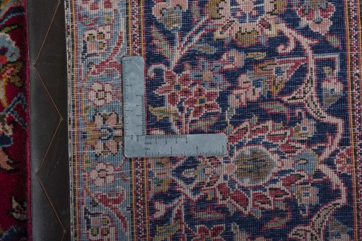 Backside of handmade 1950s Kashan rug showing knot structure and weave density