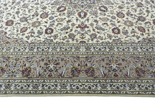 Corner detail of 2000s Kashan rug showing border pattern and Wool pile
