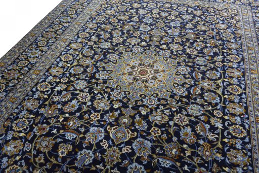 Backside of handmade 2000s Kashan rug showing knot structure and weave density