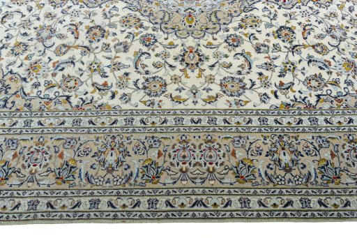 Corner detail of 2000s Kashan rug showing border pattern and Wool pile