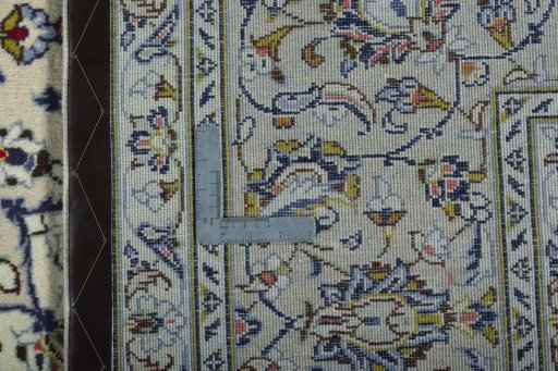 Backside of handmade 2000s Kashan rug showing knot structure and weave density