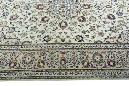 Corner detail of 2000s Kashan rug showing border pattern and Wool pile