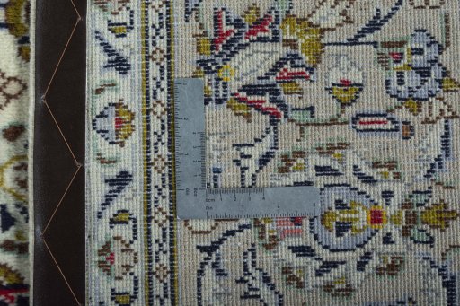 Backside of handmade 2000s Kashan rug showing knot structure and weave density