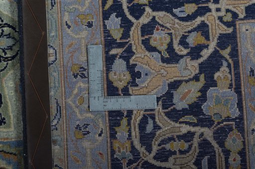 Backside of handmade 2000s Kashan rug showing knot structure and weave density