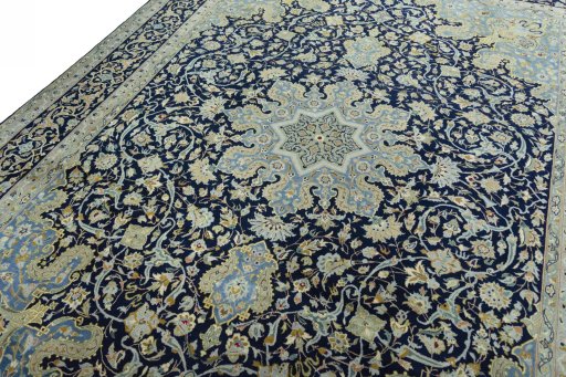 Backside of handmade 2000s Kashan rug showing knot structure and weave density