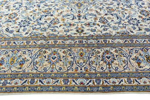Corner detail of 2000s Kashan rug showing border pattern and Wool pile