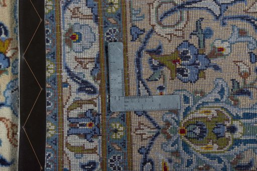 Backside of handmade 2000s Kashan rug showing knot structure and weave density
