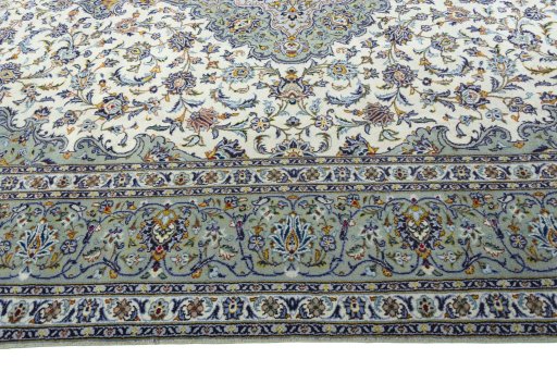 Corner detail of 2000s Kashan rug showing border pattern and Wool pile