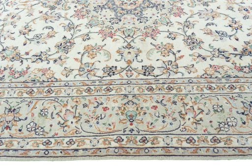 Corner detail of 2000s Kashan rug showing border pattern and Wool pile