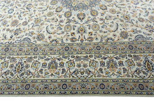 Corner detail of 2000s Kashan rug showing border pattern and Wool pile