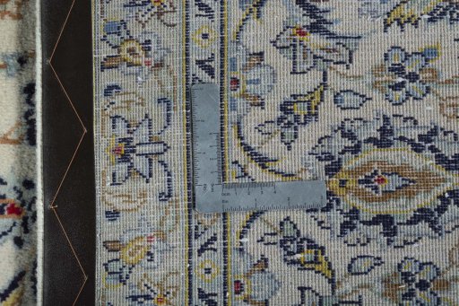 Backside of handmade 2000s Kashan rug showing knot structure and weave density