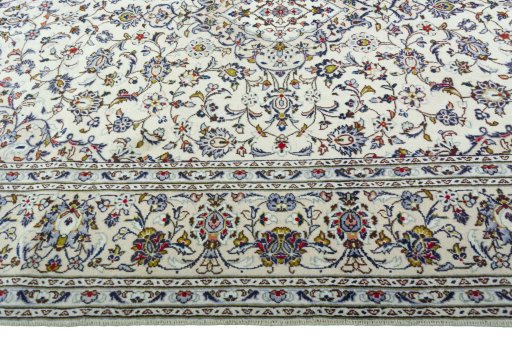 Corner detail of 2000s Kashan rug showing border pattern and Wool pile