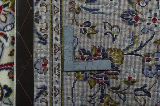 Backside of handmade 2000s Kashan rug showing knot structure and weave density