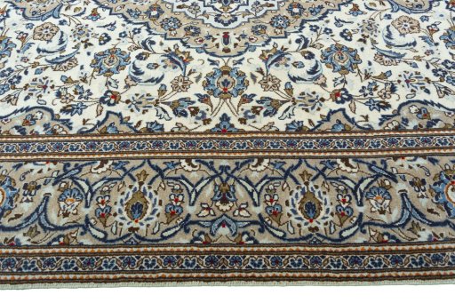 Corner detail of 2000s Kashan rug showing border pattern and Wool pile