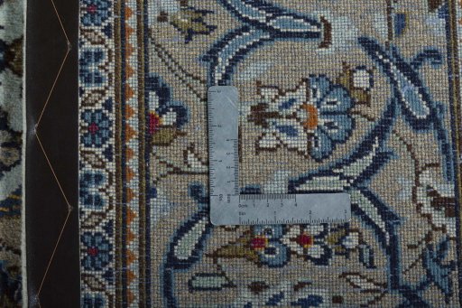 Backside of handmade 2000s Kashan rug showing knot structure and weave density