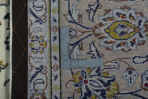 Backside of handmade 2000s Kashan rug showing knot structure and weave density