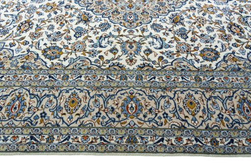 Corner detail of 2000s Kashan rug showing border pattern and Wool pile