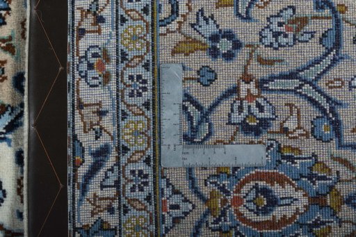 Backside of handmade 2000s Kashan rug showing knot structure and weave density