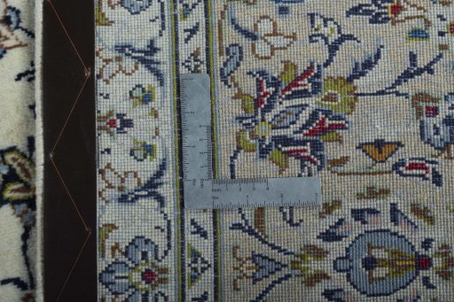 Backside of handmade 2000s Kashan rug showing knot structure and weave density
