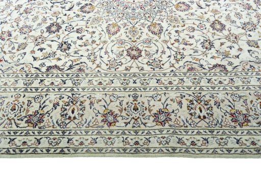 Corner detail of 2000s Kashan rug showing border pattern and Wool pile