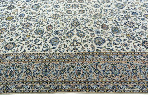 Corner detail of 2000s Kashan rug showing border pattern and Wool pile