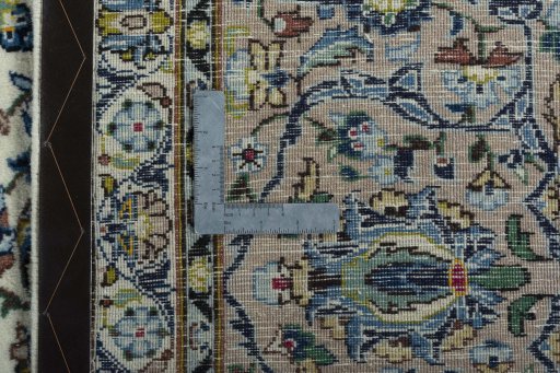 Backside of handmade 2000s Kashan rug showing knot structure and weave density