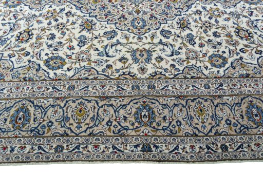 Corner detail of 2000s Kashan rug showing border pattern and Wool pile
