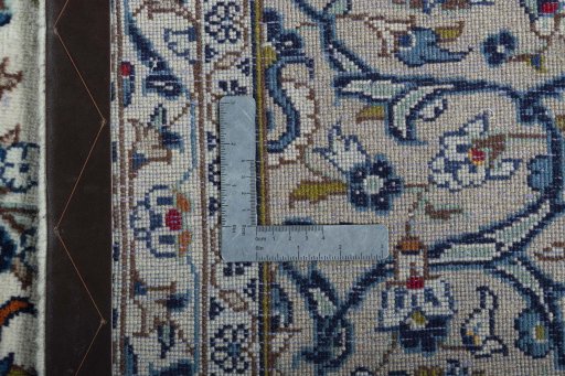 Backside of handmade 2000s Kashan rug showing knot structure and weave density