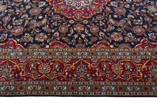 Corner detail of 2000s Kashan rug showing border pattern and Wool pile